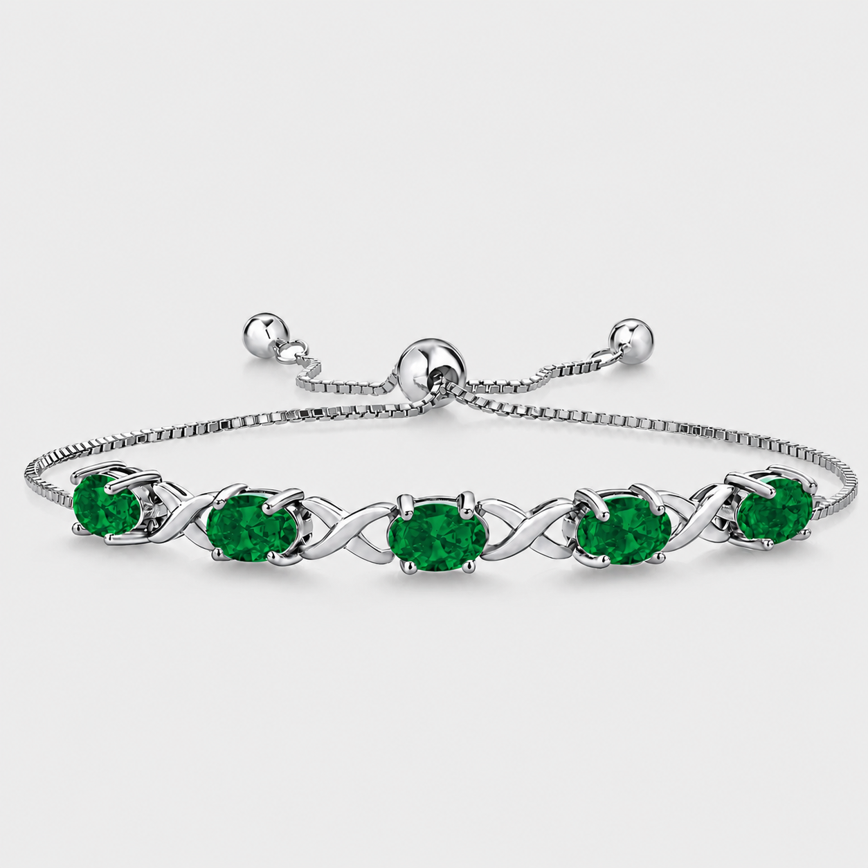 Emerald green oval cubic zirconia adjustable tennis bracelet with silver-tone infinity link design