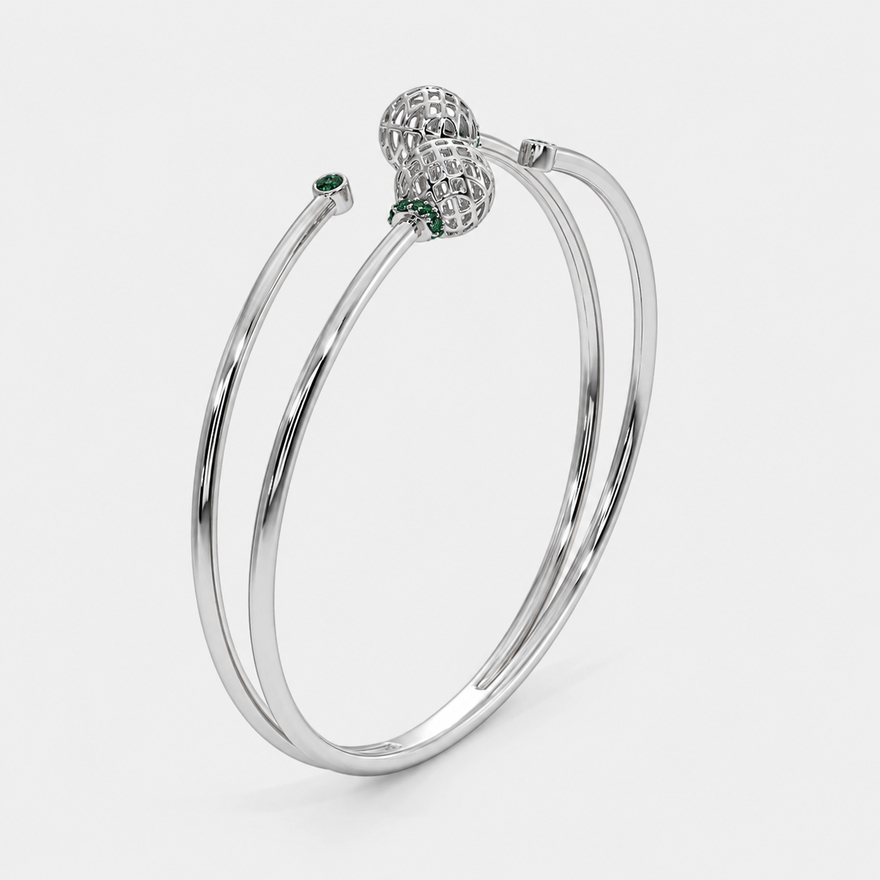 Front view of silver-tone double band cuff bracelet featuring openwork sphere accents and emerald green cubic zirconia stones