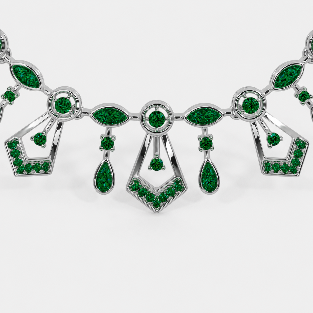Front view of silver-tone statement necklace featuring emerald green cubic zirconia accents and vintage-inspired geometric details