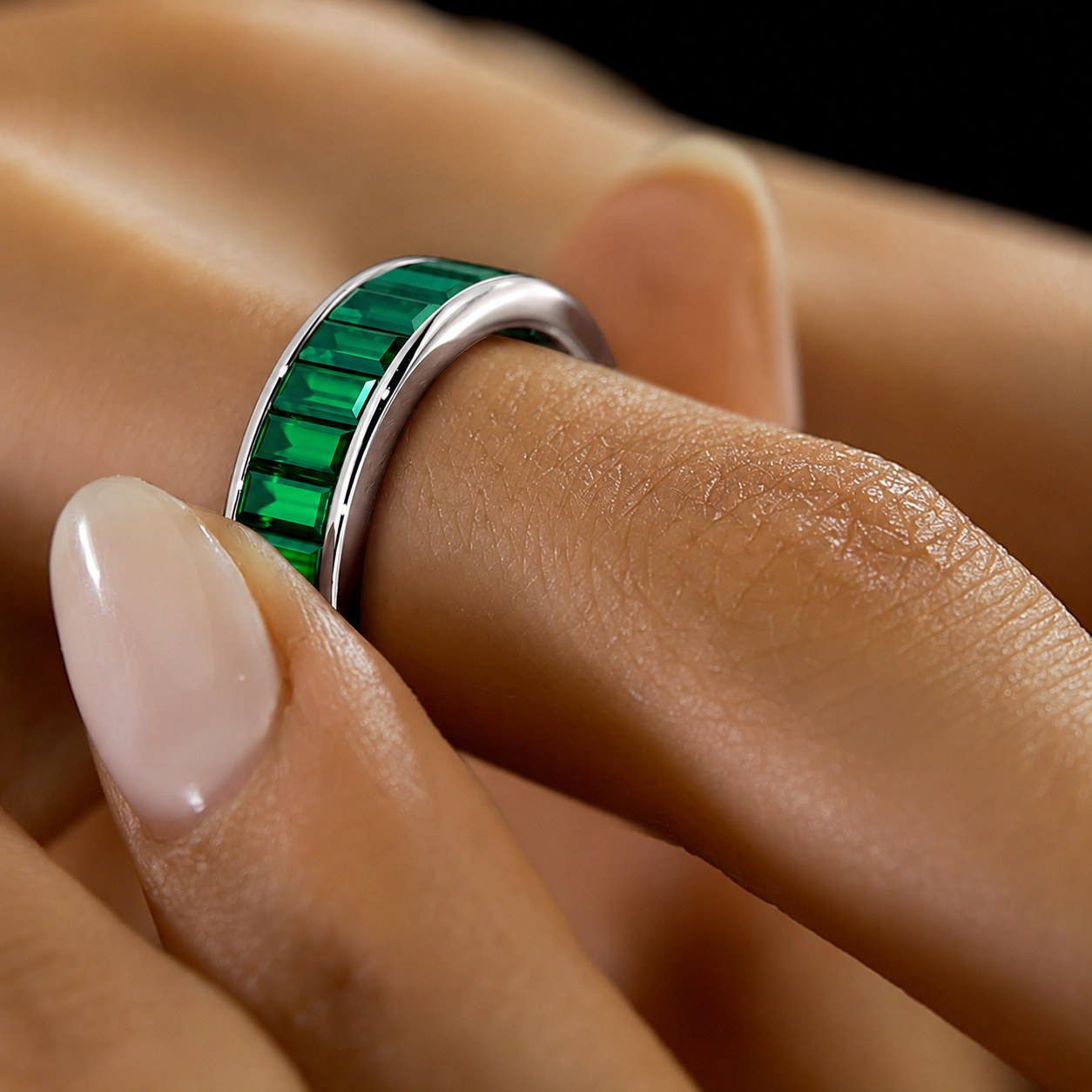 Modern silver-tone band ring showcasing emerald green rectangular cubic zirconia stones