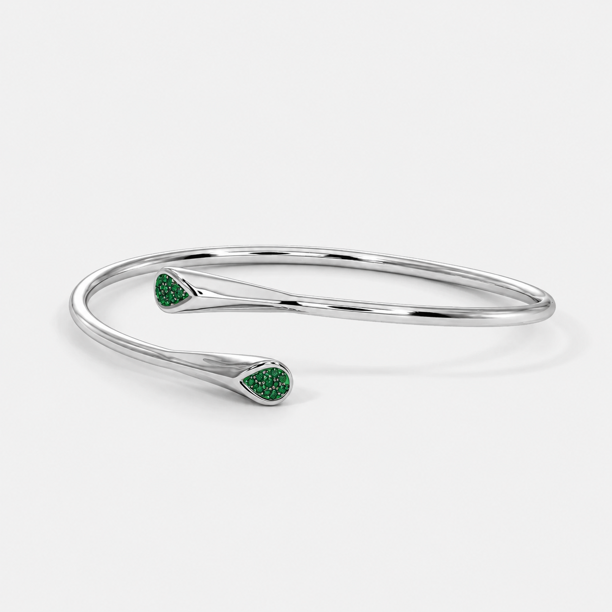 Front view of silver-tone open cuff bracelet featuring emerald green pavé cubic zirconia