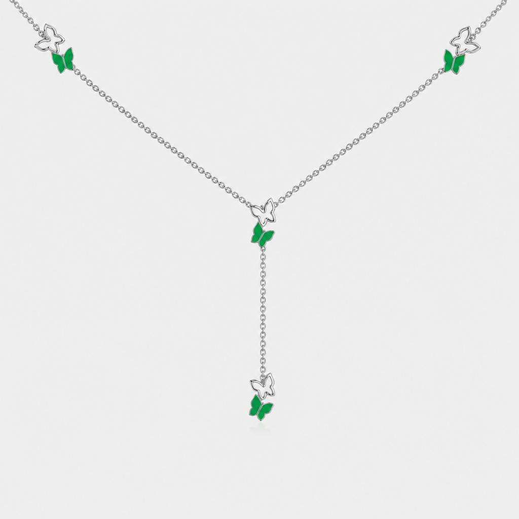 Angled view of silver-tone butterfly station necklace with emerald green gemstone-inspired accents and adjustable chain
