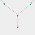 Angled view of silver-tone butterfly station necklace with emerald green gemstone-inspired accents and adjustable chain