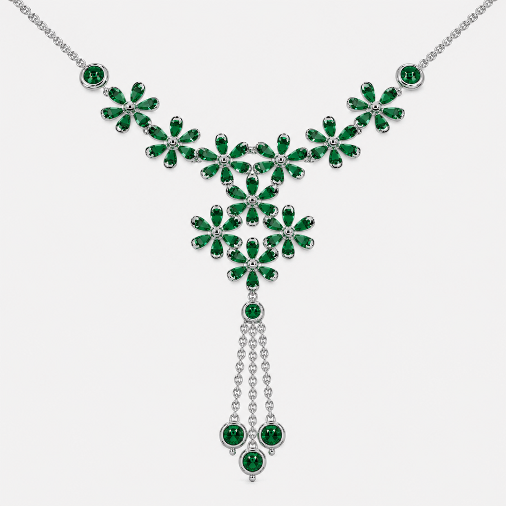 Close-up view of emerald green floral cluster centerpiece with dangling tassel accents on silver-tone necklace