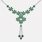Close-up view of emerald green floral cluster centerpiece with dangling tassel accents on silver-tone necklace
