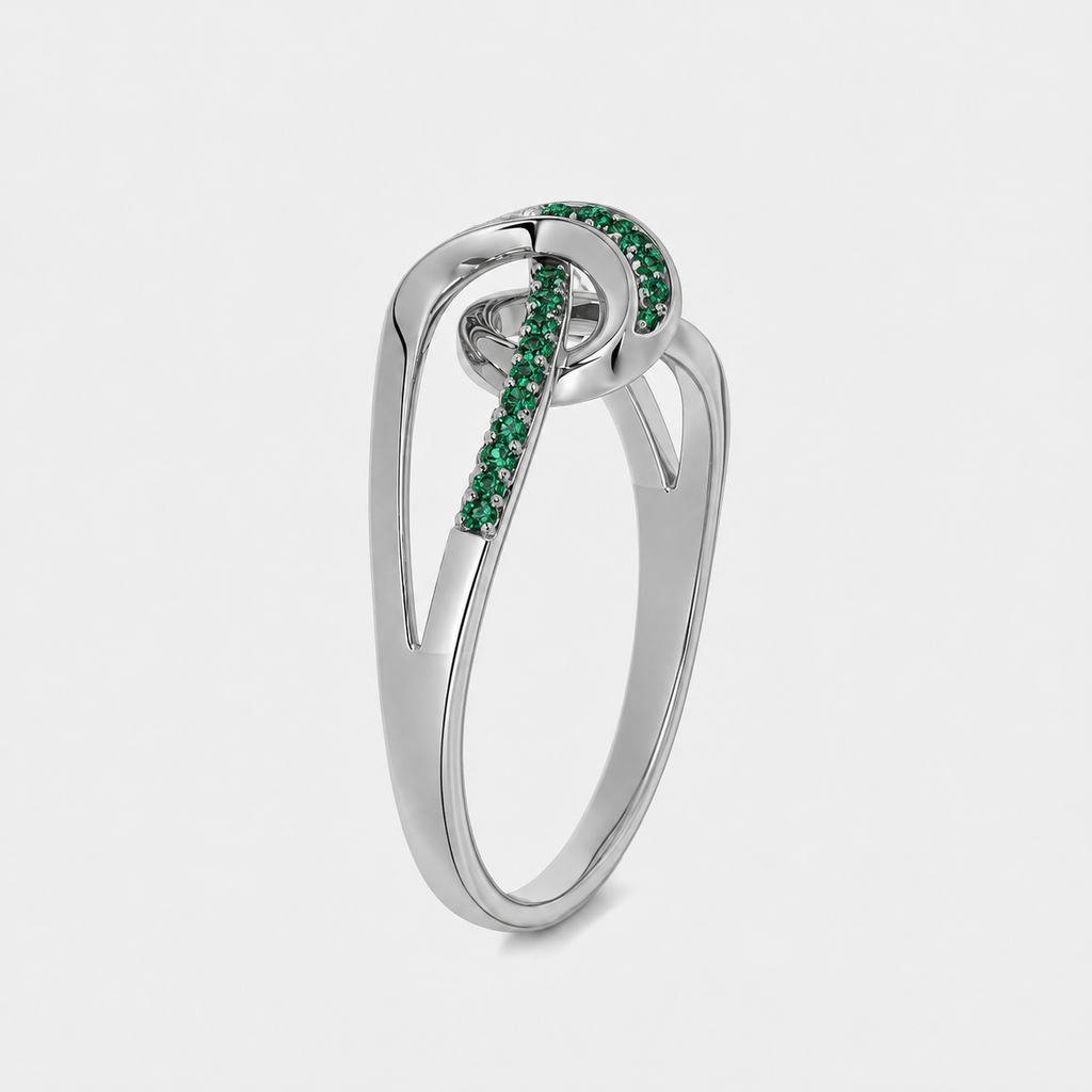 Close-up view of silver-tone openwork ring showcasing emerald green cubic zirconia detailing and polished finish