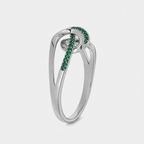 Close-up view of silver-tone openwork ring showcasing emerald green cubic zirconia detailing and polished finish