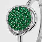 Close-up view of silver-tone ring featuring a round cluster of emerald green cubic zirconia stones