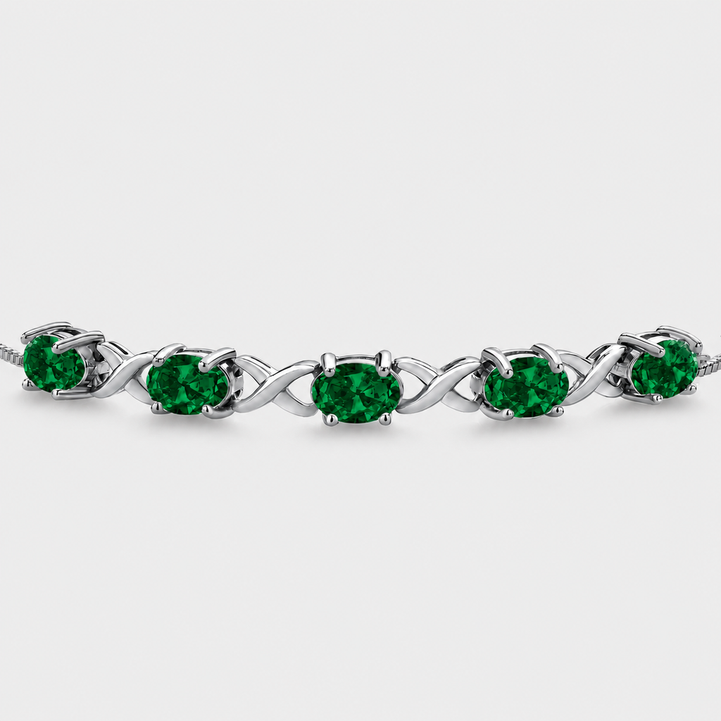 Emerald green oval cubic zirconia adjustable tennis bracelet with silver-tone infinity link design