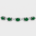 Emerald green oval cubic zirconia adjustable tennis bracelet with silver-tone infinity link design