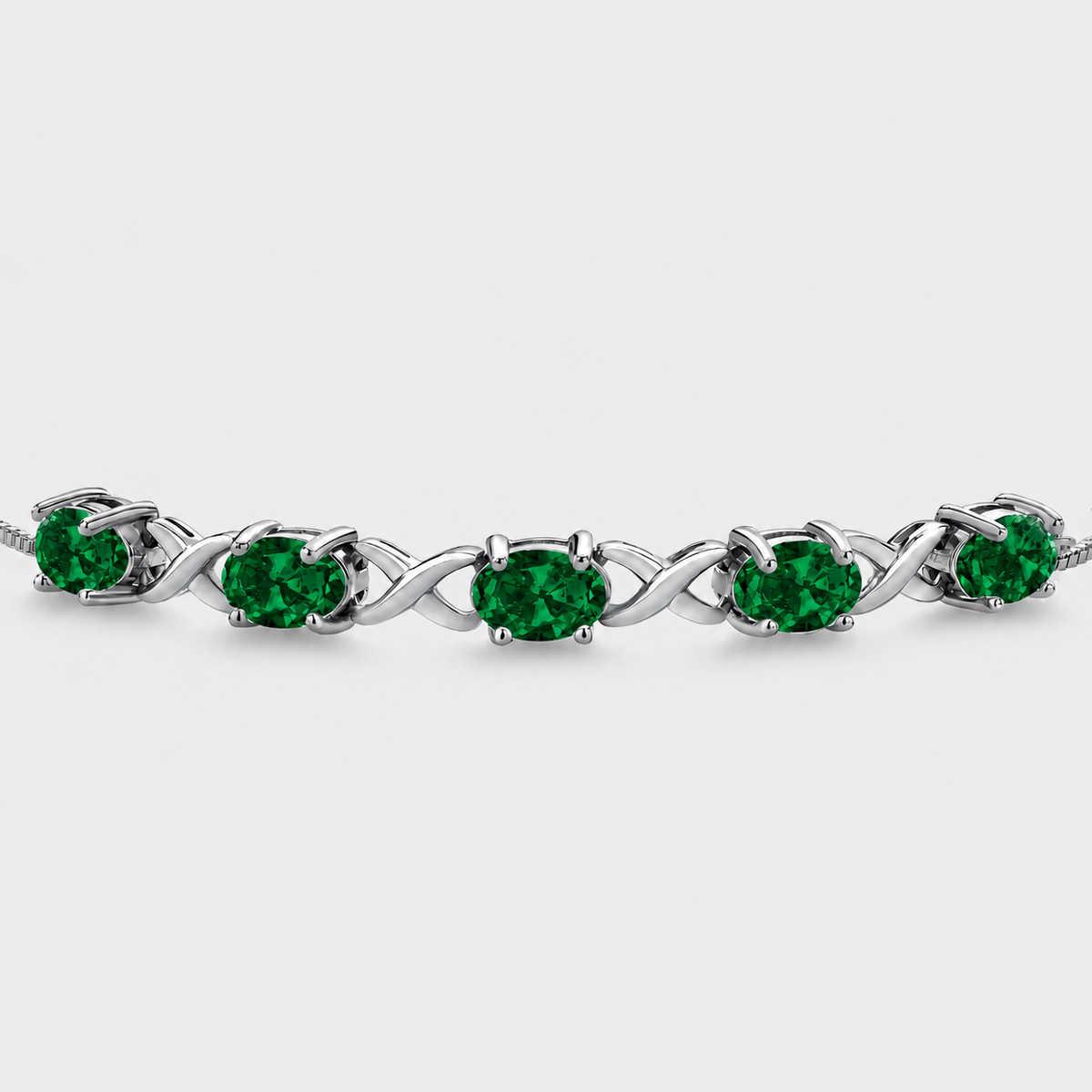Emerald green oval cubic zirconia adjustable tennis bracelet with silver-tone infinity link design