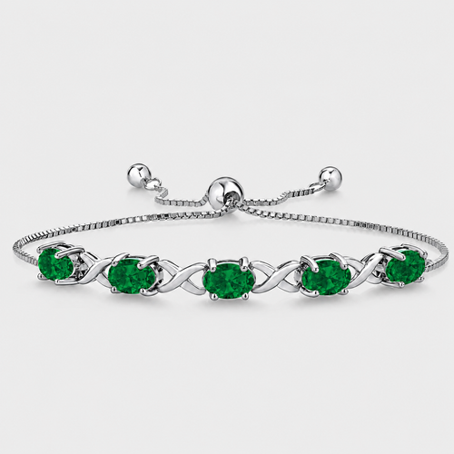 Emerald green oval cubic zirconia adjustable tennis bracelet with silver-tone infinity link design