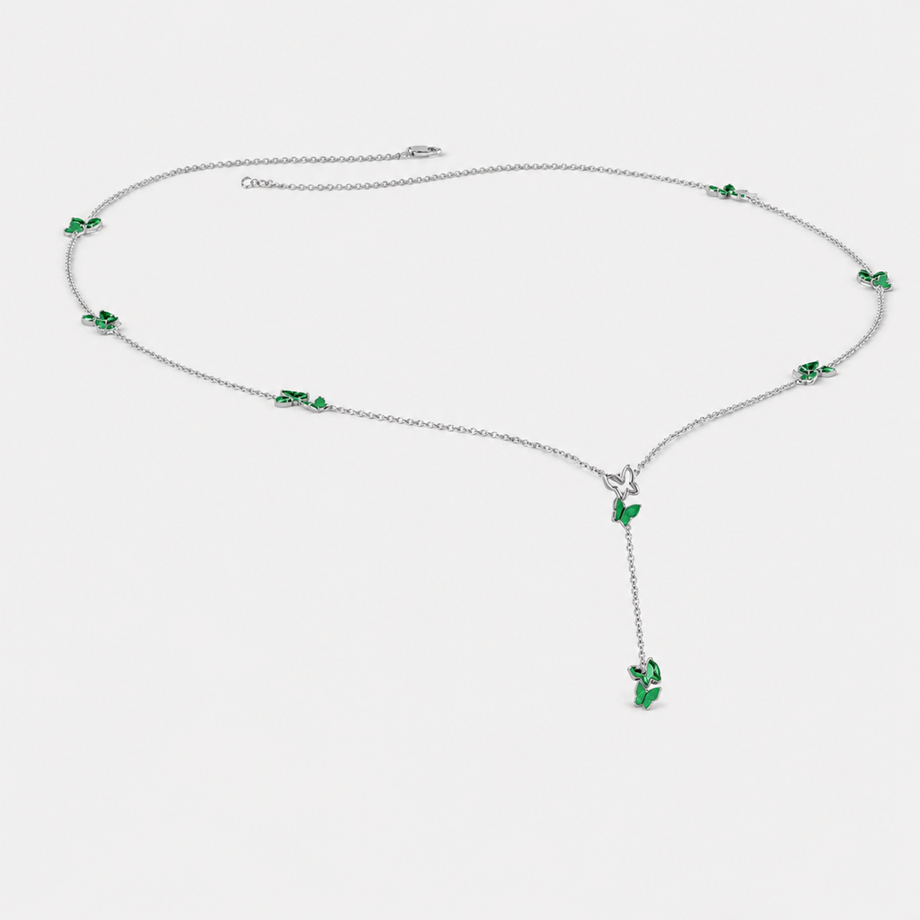Front view of silver-tone Y-drop necklace featuring emerald green butterfly-inspired cubic zirconia accents and dangling pendant detail