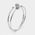 Front view of silver-tone double band cuff bracelet featuring openwork sphere accents and emerald green cubic zirconia stones