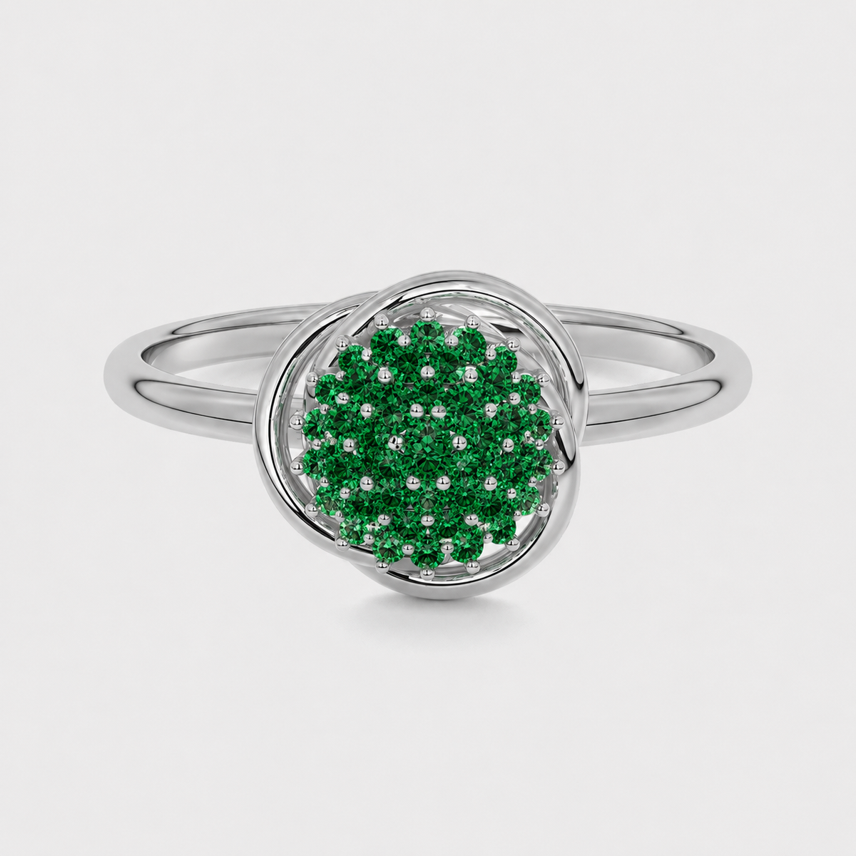 Front view of silver-tone halo ring with emerald green cubic zirconia cluster centerpiece