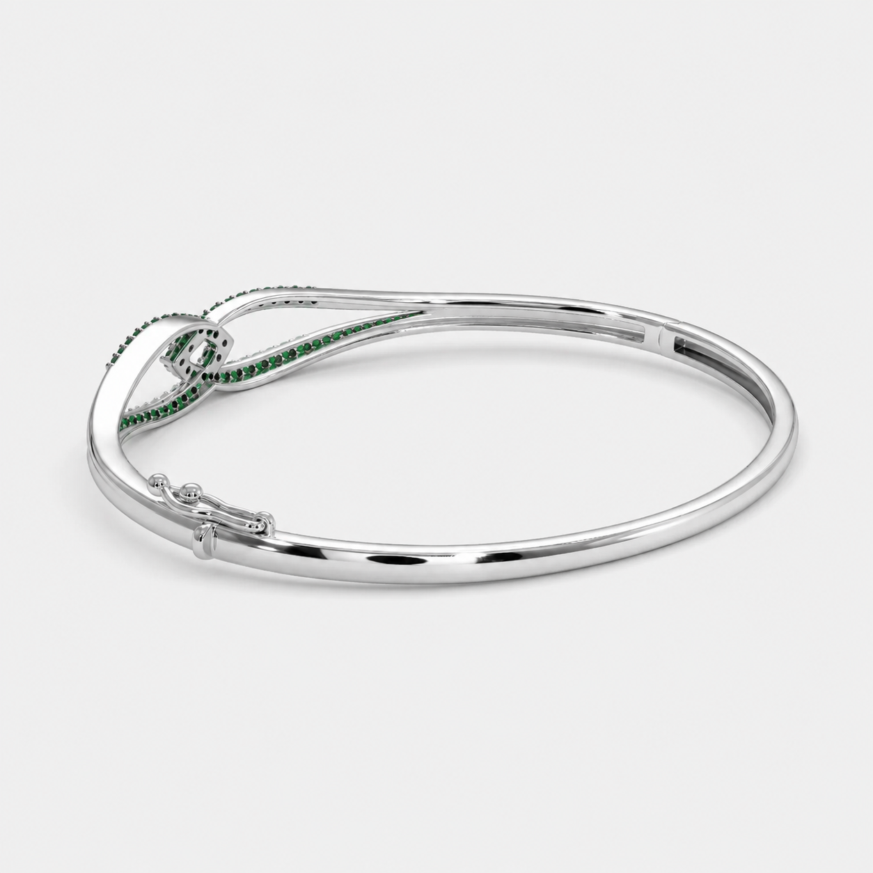 Front view of silver-tone open cuff bracelet featuring emerald green pavé cubic zirconia details