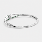 Front view of silver-tone open cuff bracelet featuring emerald green pavé cubic zirconia details