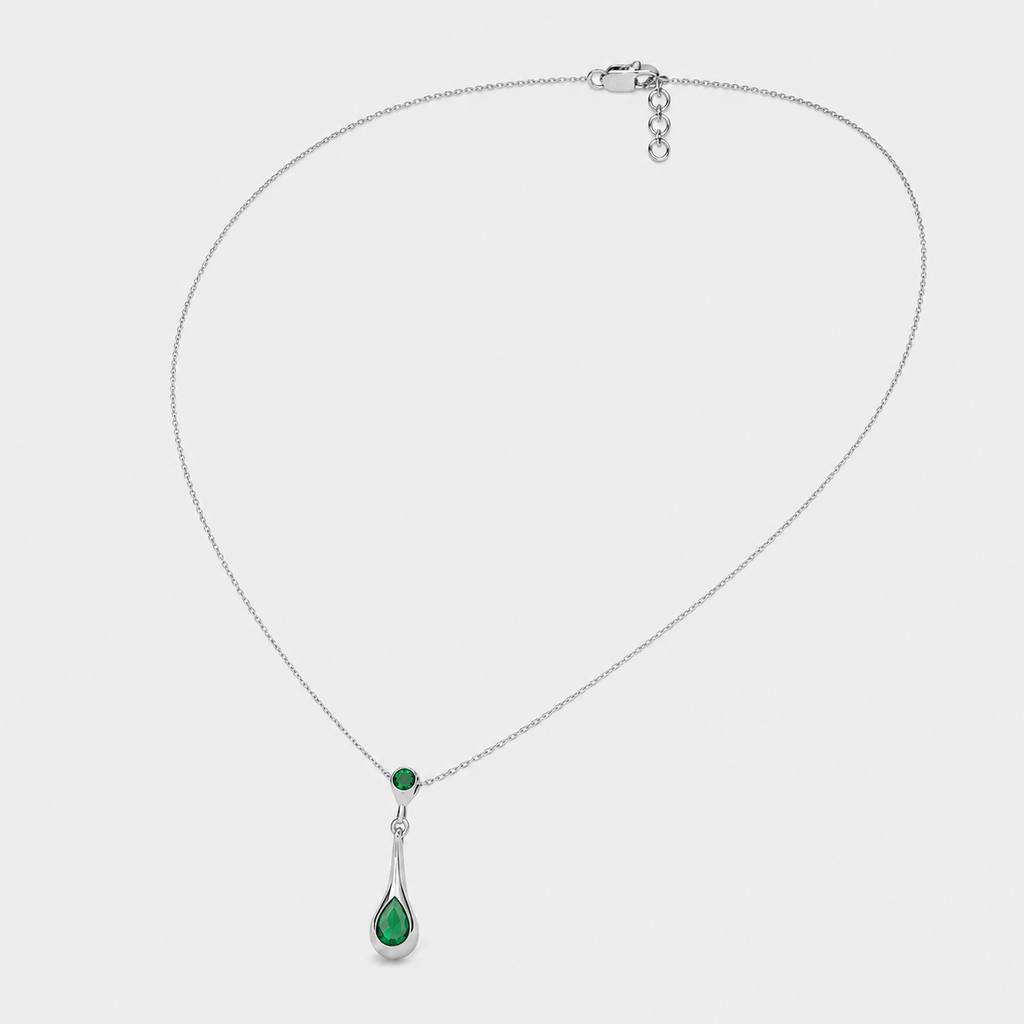 Front view of silver-tone pendant necklace featuring faceted emerald green teardrop cubic zirconia charm