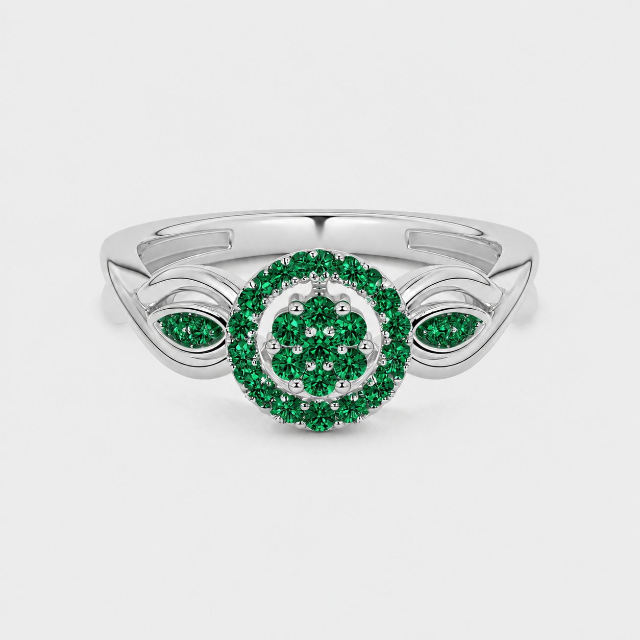 Front view of silver-tone ring showcasing round floral halo design with emerald green cubic zirconia stones