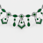 Front view of silver-tone statement necklace featuring emerald green cubic zirconia accents and vintage-inspired geometric details