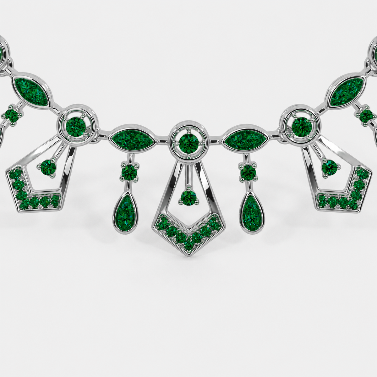Front view of silver-tone statement necklace featuring emerald green cubic zirconia accents and vintage-inspired geometric details