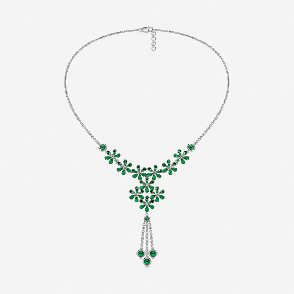 Front view of silver-tone statement necklace featuring emerald green floral cubic zirconia arrangement with tassel drop accents