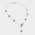 Front view of silver-tone station necklace featuring emerald green floral cubic zirconia accents and drop pendant design