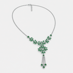 Side angle view of silver-tone statement necklace showcasing floral emerald green cubic zirconia design and tassel detail