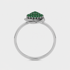 Side profile of silver-tone ring showcasing raised emerald green cubic zirconia setting
