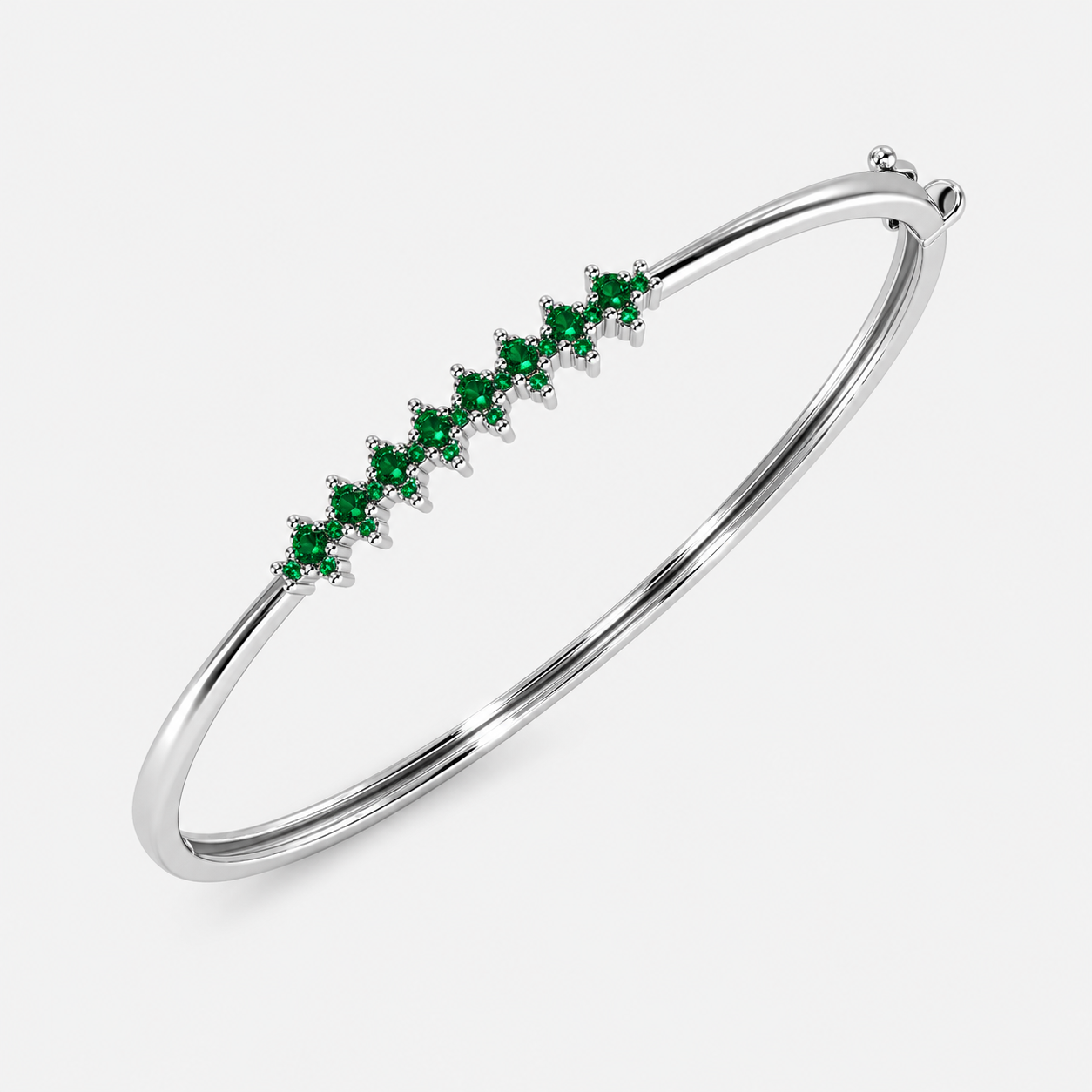 Silver-tone bangle bracelet with emerald green marquise-cut cubic zirconia stones arranged in a linear design