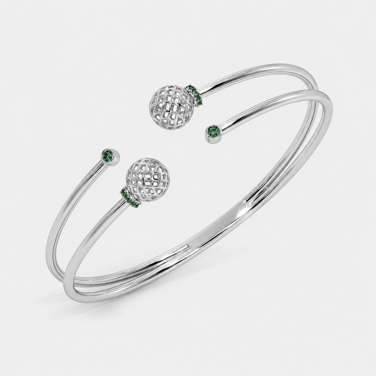 Silver-tone double band open cuff bracelet with decorative openwork sphere accents and emerald green cubic zirconia details