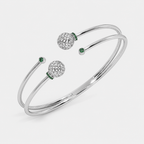 Silver-tone double band open cuff bracelet with decorative openwork sphere accents and emerald green cubic zirconia details