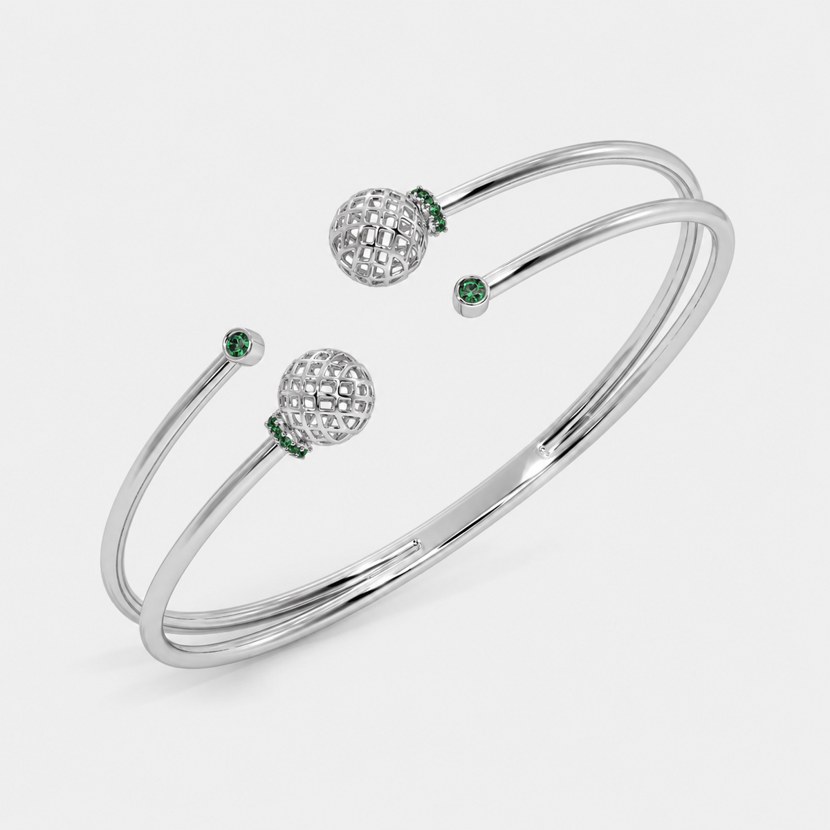 Silver-tone double band open cuff bracelet with decorative openwork sphere accents and emerald green cubic zirconia details